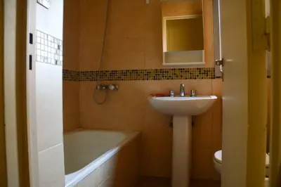 a bathroom with a sink and a tub and a toilet at Departamento en Bv. San Juan in Cordoba