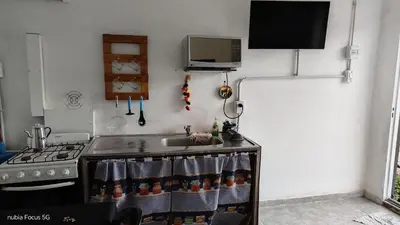 a kitchen with a counter with a sink and a stove at lo de andres y marina in Arroyo de Los Patos