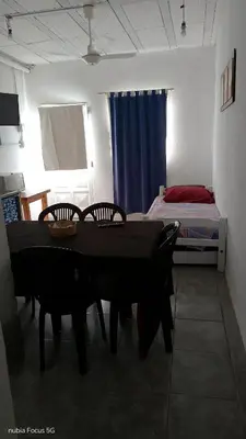 a room with a table and chairs and a bed at lo de andres y marina in Arroyo de Los Patos