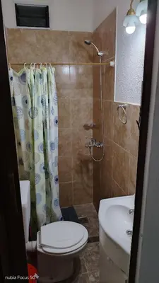 a bathroom with a toilet and a shower and a sink at lo de andres y marina in Arroyo de Los Patos