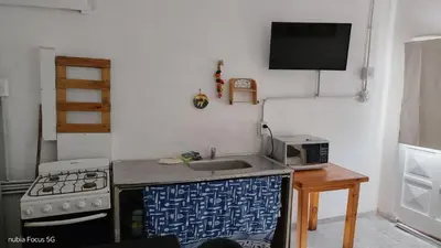 a kitchen with a sink and a stove and a microwave at lo de andres y marina in Arroyo de Los Patos