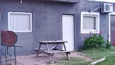 a picnic table sitting in front of a house at lo de andres y marina in Arroyo de Los Patos