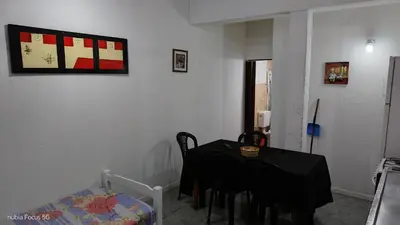 a room with a table and chairs and a bed at lo de andres y marina in Arroyo de Los Patos