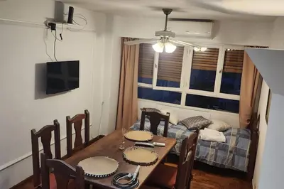 a dining room with a table and a couch at Cordoba Centro in Cordoba