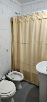 a bathroom with a toilet and a shower curtain at Cordoba Centro in Cordoba