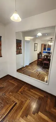 a room with a mirror and a dining room at Cordoba Centro in Cordoba