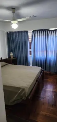 a bedroom with a bed and blue curtains at Cordoba Centro in Cordoba