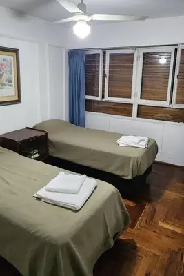 a room with two beds with towels on them at Cordoba Centro in Cordoba