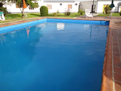 a large swimming pool with blue water at Hotel Lujan in Luján