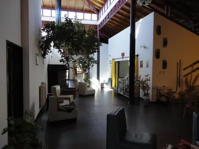 a lobby with couches and chairs in a building at Hotel Lujan in Luján