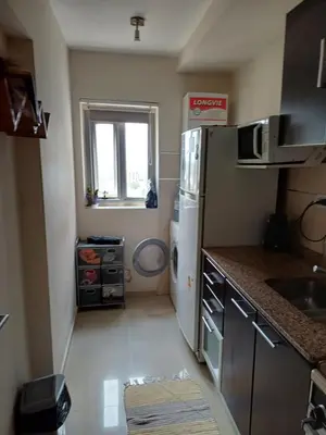 a small kitchen with a refrigerator and a window at Alto Villasol depto torre bastion in Cordoba