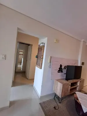 a living room with a tv and a table at Alto Villasol depto torre bastion in Cordoba