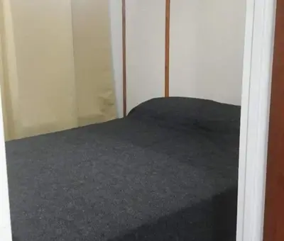 a bed in a room with a closet at Cabaña 2 in Cordoba