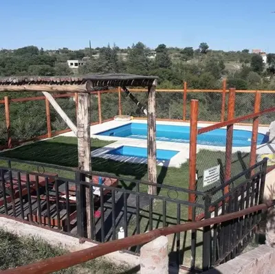 a swimming pool with a fence around it at Cabaña 3 in Bialet Massé