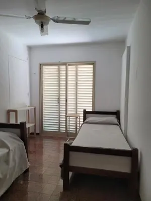 a bedroom with two beds and a ceiling fan at Hotel CAMACHO in Cordoba