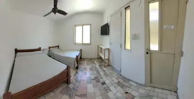 a bedroom with two beds and a window and a door at Hotel CAMACHO in Cordoba