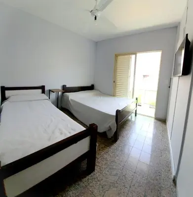 two beds in a room with a window at Hotel CAMACHO in Cordoba