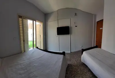 a bedroom with two beds and a flat screen tv at Hotel CAMACHO in Cordoba