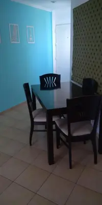 a dining room table and chairs with a blue light at Cálido departamento en CBA in Cordoba