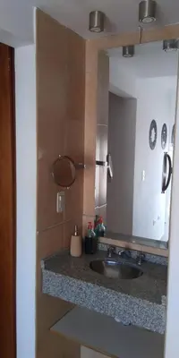a bathroom with a sink and a large mirror at Cálido departamento en CBA in Cordoba