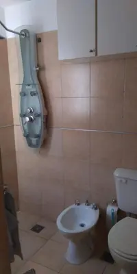 a bathroom with a toilet and a sink at Cálido departamento en CBA in Cordoba