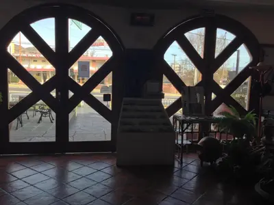 a room with a view of a courtyard through a window at Hotel Verde Sol in Villa Carlos Paz