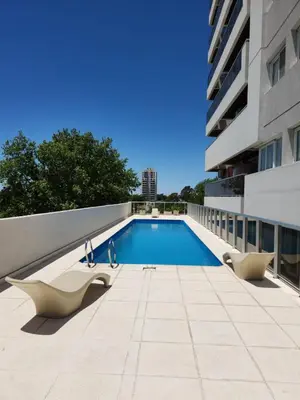 a swimming pool on the side of a building at TORRE MAFALDA 15 Departamento nuevo con Pileta in Río Cuarto