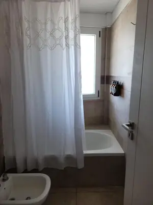a bathroom with a tub and a shower curtain at TORRE MAFALDA 15 Departamento nuevo con Pileta in Río Cuarto