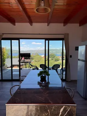 a table in a kitchen with a view of the mountains at EL PALMAR in Villa Carlos Paz