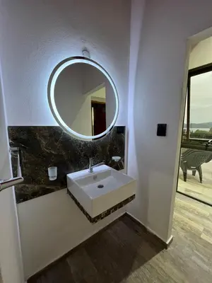 a bathroom with a white sink and a mirror at EL PALMAR in Villa Carlos Paz