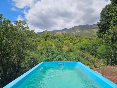 a swimming pool with a view of the mountains at Nuestro Balcón a las Sierras in Merlo