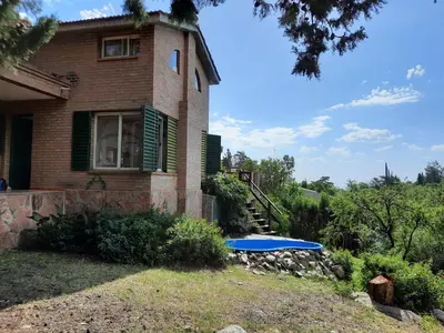 a house with a blue trampoline in front of it at Nuestro Balcón a las Sierras in Merlo