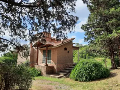 an old brick building with stairs in a field at Nuestro Balcón a las Sierras in Merlo