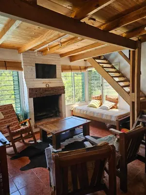 a living room with a bed and a fireplace at Nuestro Balcón a las Sierras in Merlo