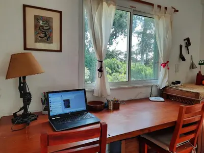 a desk with a laptop computer on top of it at Nuestro Balcón a las Sierras in Merlo