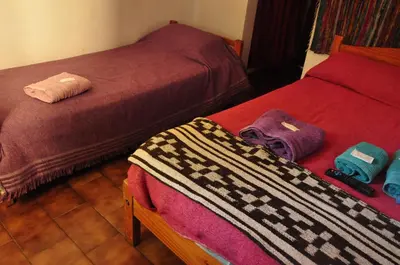 a bedroom with two beds with towels on them at Hotel La Marina in Villa Carlos Paz