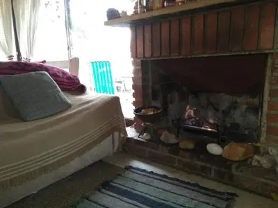 a bedroom with a bed next to a fireplace at Hotel La Marina in Villa Carlos Paz