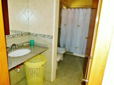 a bathroom with a sink and a toilet and a shower at Cabañas Amanecer en el Lago in Villa del Dique