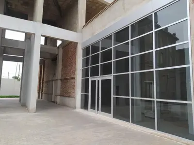 an empty building with large glass windows on the side at Dto Costanera Antigua Cerveceria 3 dorm 2 cocheras 4 cuadras del centro in Cordoba