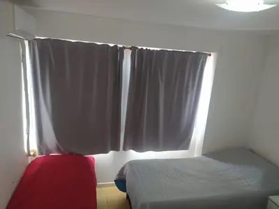 a bedroom with a bed and a window with white curtains at Dto Costanera Antigua Cerveceria 3 dorm 2 cocheras 4 cuadras del centro in Cordoba