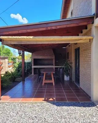a patio with awning and a picnic table at Cabañas Brick House in Embalse