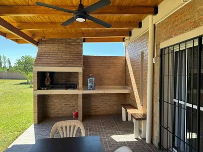 a patio with a table and a ceiling fan at Julias House in Almafuerte