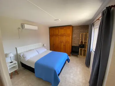 a bedroom with a blue and white bed and a window at Julias House in Almafuerte