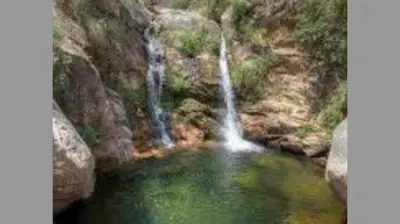 a small pool of water with two waterfall at Casa de Montaña in Cortaderas