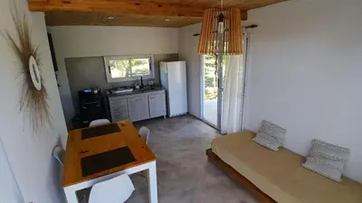 a kitchen with a couch and a table in a room at Casa de Montaña in Cortaderas