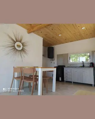 a kitchen and dining room with a table and chairs at Casa de Montaña in Cortaderas