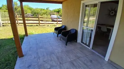 a screened porch with two chairs and a table at Casa de Montaña in Cortaderas