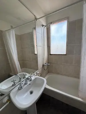 a bathroom with a sink and a bath tub at Nueva Cordoba Illia 611 in Cordoba