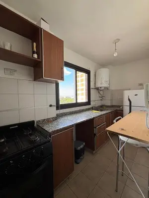 a kitchen with a black stove and a window at Nueva Cordoba Illia 611 in Cordoba
