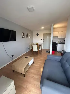 a living room with a blue couch and a table at Richardson in Cordoba